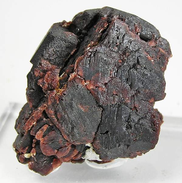 A deep red garnet crystal shown as a gemstone reference